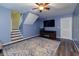 Cozy living room with a ceiling fan, a wall-mounted TV, and adjacent staircase to upper floors at 1341 Inman Ct, Norcross, GA 30093