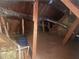 Unfinished attic space with exposed wooden beams, insulation, pipes, and blue bucket for storage at 159 Tara Blvd, Loganville, GA 30052