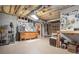 Unfinished basement featuring open ceiling, concrete floor, workbench, and ample storage space at 159 Tara Blvd, Loganville, GA 30052