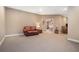 Spacious finished basement with neutral carpet, cozy seating, and open doorway to other rooms at 159 Tara Blvd, Loganville, GA 30052