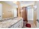 Bathroom with granite countertop, white cabinets, toilet, and shower/tub combo with curtain at 159 Tara Blvd, Loganville, GA 30052