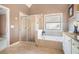 Elegant bathroom featuring tub, shower and white cabinets at 159 Tara Blvd, Loganville, GA 30052