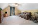 Bright, carpeted bedroom under vaulted ceiling with daybed, rocking chair, and TV on wooden dresser at 159 Tara Blvd, Loganville, GA 30052
