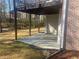View of a covered porch area with brick house, offering potential for outdoor entertainment at 159 Tara Blvd, Loganville, GA 30052
