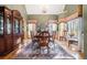 Formal dining room with hardwood floors, elegant chandelier, and large windows at 159 Tara Blvd, Loganville, GA 30052