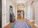 Inviting entryway with hardwood floors, decorative mirror and rug, arched doorway, and view into the living room at 159 Tara Blvd, Loganville, GA 30052