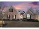 Charming single-Gathering brick home with mature landscaping and black shutters at dusk at 159 Tara Blvd, Loganville, GA 30052