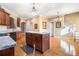 Light and bright kitchen with an island, hardwood floors, granite countertops, and wood cabinets at 159 Tara Blvd, Loganville, GA 30052
