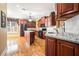 Well-equipped kitchen features granite countertops, dark wood cabinetry, and hardwood floors at 159 Tara Blvd, Loganville, GA 30052