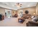 Spacious living room with plush carpeting, a ceiling fan, and comfortable seating arrangement at 159 Tara Blvd, Loganville, GA 30052