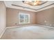 Spacious main bedroom with tray ceiling and a window to the backyard at 159 Tara Blvd, Loganville, GA 30052