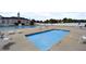 Community pool with lounge chairs, umbrellas and well-maintained decking for relaxing at 159 Tara Blvd, Loganville, GA 30052