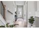 Bright hallway featuring hardwood floors, an elegant console table, and a view of the front door at 3543 Cedarvale Ct, Powder Springs, GA 30127