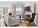 Sun-filled living room features a white brick fireplace, hardwood floors, and neutral-toned furnishings at 3543 Cedarvale Ct, Powder Springs, GA 30127