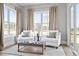 Sun-filled sitting area with two armchairs, a small table and light-colored rug and walls at 3543 Cedarvale Ct, Powder Springs, GA 30127