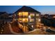 Aerial view of this home showcasing its outdoor decks, stone patio, fire pit, and manicured landscaping at 4440 Croftshire Pl, Cumming, GA 30040