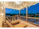 Inviting back porch with lounge furniture and ambient lighting, perfect for relaxing outdoors at 4440 Croftshire Pl, Cumming, GA 30040