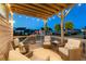 Back porch with a wood ceiling, decorative lighting and cushioned seating that overlooks the backyard and pond at 4440 Croftshire Pl, Cumming, GA 30040