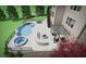 This backyard features a custom-designed swimming pool, spa, outdoor seating area with a fireplace, and professional landscaping at 4440 Croftshire Pl, Cumming, GA 30040