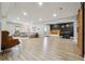 Spacious basement with wood-look flooring, a barn door, and a stylish bar area at 4440 Croftshire Pl, Cumming, GA 30040