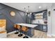 Stylish basement bar area with sleek countertops, built-in shelving, and modern barstools at 4440 Croftshire Pl, Cumming, GA 30040