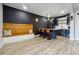 Chic basement bar features accent wall, beverage fridge, and wood bench seating at 4440 Croftshire Pl, Cumming, GA 30040