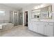 Elegant bathroom with a soaking tub, glass shower, and double vanity with ample counter space at 4440 Croftshire Pl, Cumming, GA 30040