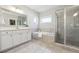 Bright bathroom with a tub, walk-in shower, and modern vanity with ample counter space at 4440 Croftshire Pl, Cumming, GA 30040