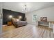 Large bedroom features a modern accent wall, ample lighting, and wood-look flooring at 4440 Croftshire Pl, Cumming, GA 30040