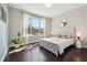 Well-lit bedroom with hardwood floors, a large window and neutral decor at 4440 Croftshire Pl, Cumming, GA 30040