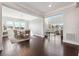 Open-concept dining and living rooms with hardwood floors, modern lighting and large windows allowing lots of natural light at 4440 Croftshire Pl, Cumming, GA 30040