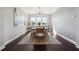 Bright dining room featuring a modern chandelier, six-chair table set, large windows and elegant neutral rug at 4440 Croftshire Pl, Cumming, GA 30040