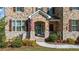 Charming two-story home featuring a stone facade, manicured lawn, and inviting front entrance at 4440 Croftshire Pl, Cumming, GA 30040