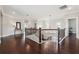 Bright hallway featuring hardwood floors and decorative lighting leading to multiple rooms at 4440 Croftshire Pl, Cumming, GA 30040