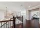 Second floor hallway with hardwood floors, iron railings and views to the open concept living spaces below at 4440 Croftshire Pl, Cumming, GA 30040