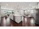Open kitchen and living area with stainless appliances, large island and lots of light at 4440 Croftshire Pl, Cumming, GA 30040