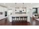 Elegant kitchen with island, stainless appliances, pendant lights and white cabinets at 4440 Croftshire Pl, Cumming, GA 30040