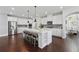 Spacious kitchen with island, stainless appliances, pendant lighting and white cabinets at 4440 Croftshire Pl, Cumming, GA 30040