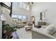 Bright living room with a soaring ceiling, a fireplace, neutral furnishings, large windows, and hardwood floors at 4440 Croftshire Pl, Cumming, GA 30040
