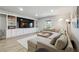 Cozy living room features a large sectional sofa, custom built-ins, and ample natural light at 4440 Croftshire Pl, Cumming, GA 30040