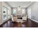 Neutral toned living room with hardwood floors, a door to the balcony, modern lighting and a door to the pantry at 4440 Croftshire Pl, Cumming, GA 30040