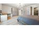 This main bedroom is bright and features built-in storage, a custom desk and light wood floors at 4440 Croftshire Pl, Cumming, GA 30040