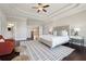 Spacious main bedroom with tray ceilings, modern furnishings and an en suite bath at 4440 Croftshire Pl, Cumming, GA 30040