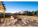 A patio view featuring an outdoor fire pit, with adirondack chairs, and views of the surrounding neighborhood at 4440 Croftshire Pl, Cumming, GA 30040