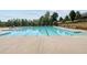 A stunning community pool with lounge chairs and umbrellas for residents at 4440 Croftshire Pl, Cumming, GA 30040