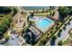 Aerial view of the community pool, playground, and pond surrounded by lush landscaping and walking trail at 4440 Croftshire Pl, Cumming, GA 30040
