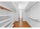 Spacious walk-in closet with custom shelving and hardwood floors at 455 Glen Iris Ne Dr # D, Atlanta, GA 30308