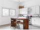 Bright kitchen featuring white cabinetry, stainless steel appliances, and a wooden island with bar seating at 455 Glen Iris Ne Dr # D, Atlanta, GA 30308