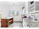 Contemporary kitchen featuring white cabinets, tiled backsplash, stainless steel appliances, and island with seating at 455 Glen Iris Ne Dr # D, Atlanta, GA 30308