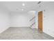 Open-concept living area with polished concrete floors and a staircase to the upper level at 455 Glen Iris Ne Dr # D, Atlanta, GA 30308